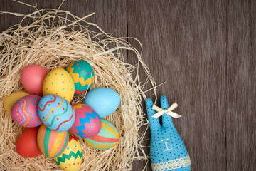 Easter eggs hand painted, rabbit, wood background