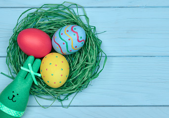 Easter eggs hand painted, rabbit, wood background