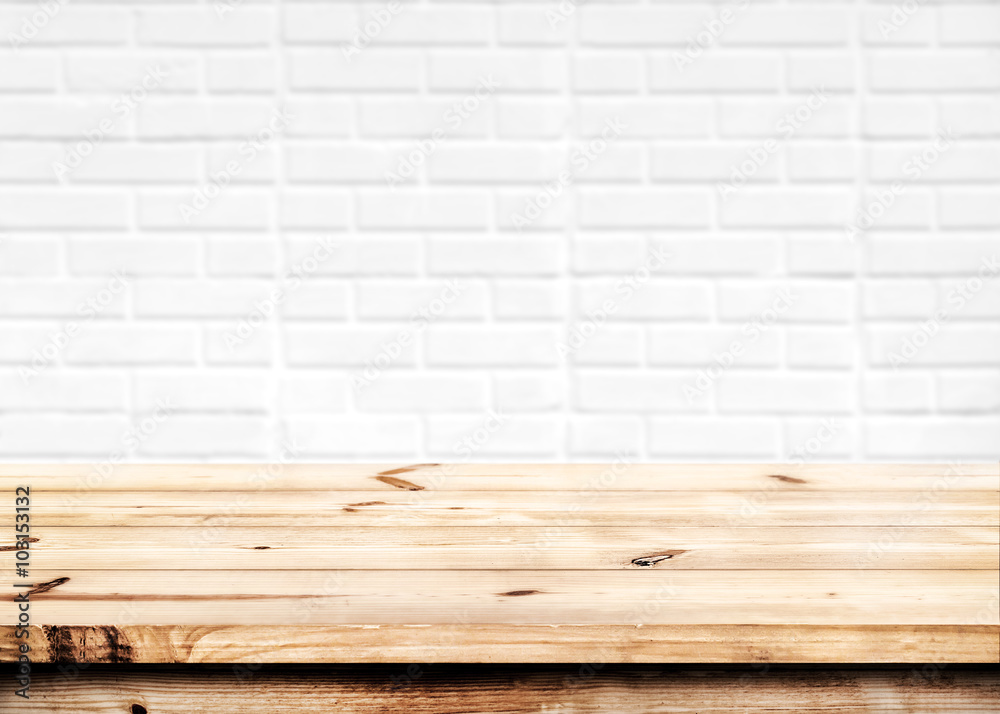 Wall mural empty wooden table for product placement or montage with focus to the table top in the foreground, w