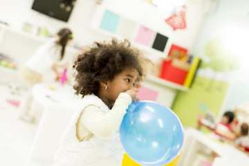 Black little girl with a balloon