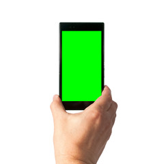 Man holds in hand smartphone in portrait mode with green screen isolated on white. Chroma key screen for placement of your own content.
