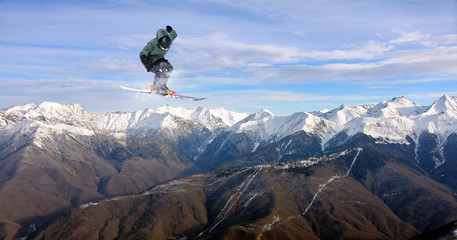 Flying skier on mountains. Extreme sport.