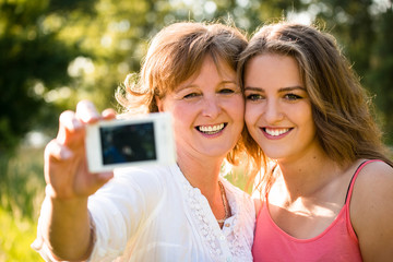 Senior mother with daughter selfie
