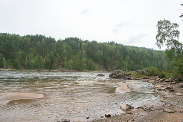 A small beach on a forest river in Siberia