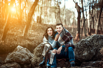 Young happy couple outdoor on the stones