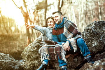 Young happy couple outdoor on the stones