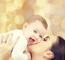 laughing baby playing with mother