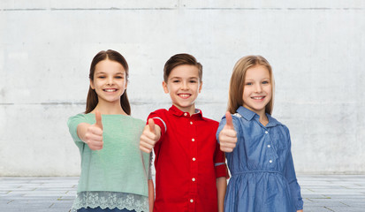 happy children showing thumbs up