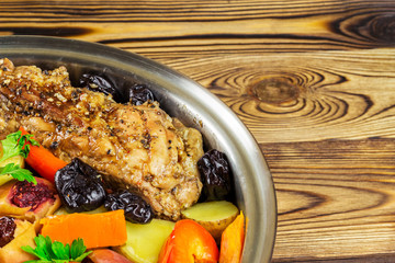 Healthy food, stewed pork meat with various colorful vegetables in pan on wooden background, space for text