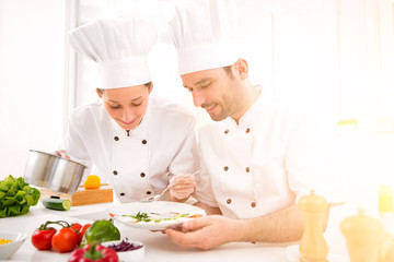 Young attractives professionals chefs cooking together