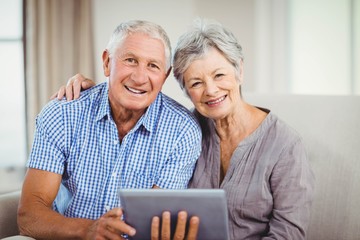 Portrait of senior couple with digital tablet