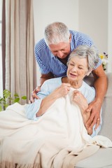 Senior man embracing woman at home