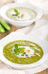 Green pea soup in bowls.