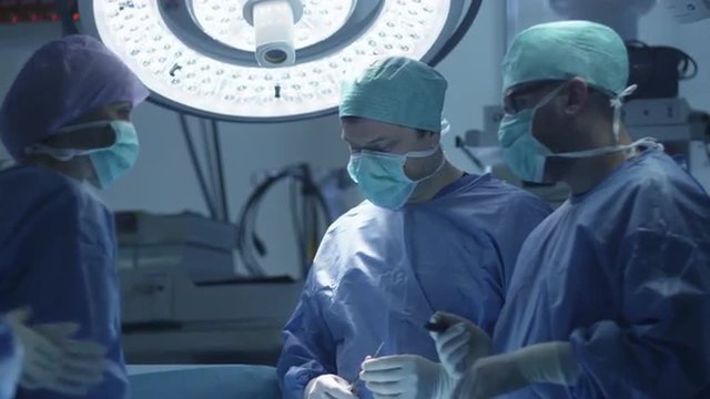 Surgeon Making Decision During Operation. Shot on RED Cinema Camera.