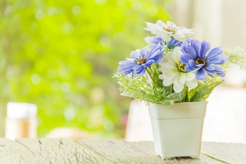 Fake flowers on wood