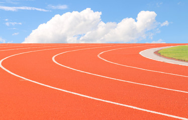 Fototapeta premium track running, Red treadmill in sport field with sky soft focus