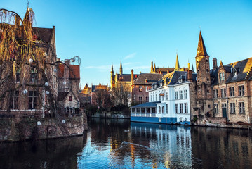 Naklejka na ściany i meble Bruges, Belgium. Image with Rozenhoedkaai in Brugge, Dijver river canal.
