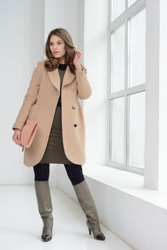 Girl in studio posing at coat