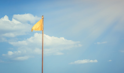 Fototapeta premium Yellow flag and blue sky