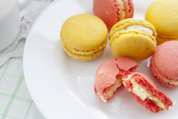 Colorful french macaroons in white dish with soft vintage color