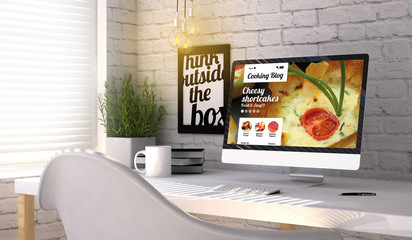 Stylish workplace with computer with cooking blog on the screen