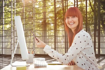 Composite image of smiling hipster woman pointing screen