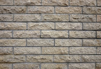 Fototapeta premium Beige tile cladded stone wall texture 