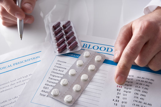 Doctor prescribing drugs and showing blood test report