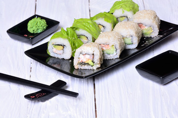 Sushi rolls on wooden background