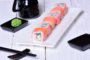 Sushi rolls on wooden background