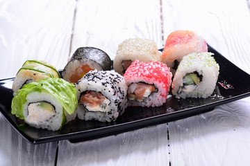 Sushi rolls on wooden background