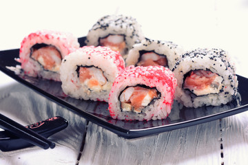 Sushi rolls on wooden background