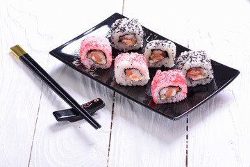 Sushi rolls on wooden background