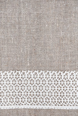 Fototapeta premium Vintage background with lace fabric on burlap