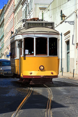 Fototapeta na wymiar Beautiful traditional yellow tram in the streets of Lisbon, Portugal, in summer