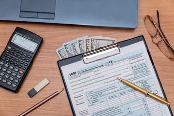 tax form with computer on table
