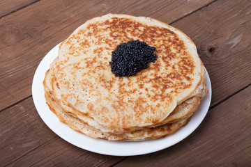 Black caviar on Russian pancakes - blini