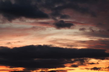 Reddish and cloudy sky at sunset in Bregenz, Austria.