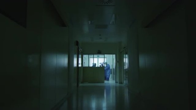 Hospital Emergency Team Carrying Stretcher with Patient through Hospital Hall. Shot on RED Cinema Camera.