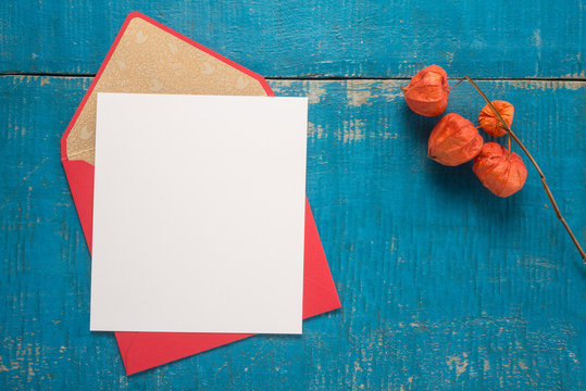 Flowers and envelope on a wooden background 
