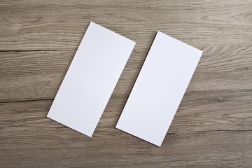 Blank flyer over wooden background to replace your design.