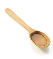 wooden spoon and honey on white