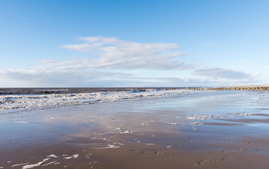 relaxing and gentle calming waves flowing into a beach at sundown