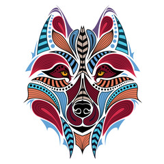 Naklejka premium Patterned colored head of the wolf. African / indian / totem / tattoo design. It may be used for design of a t-shirt, bag, postcard and poster.
