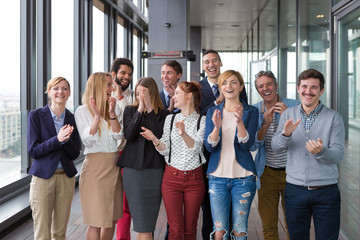 Group shot of business people in modern office hall.