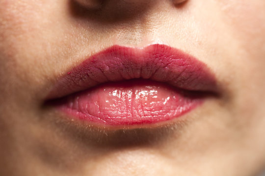 Closeup of beautiful sexy plump red woman lips with lipstick