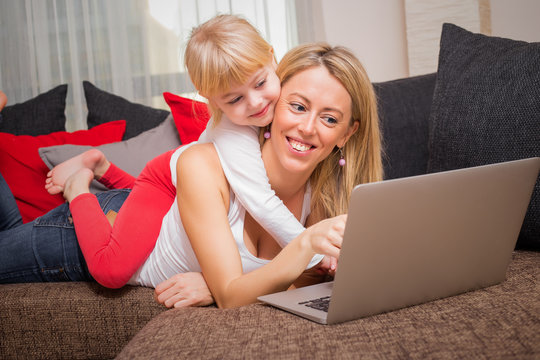 Mother and daughter using laptop 