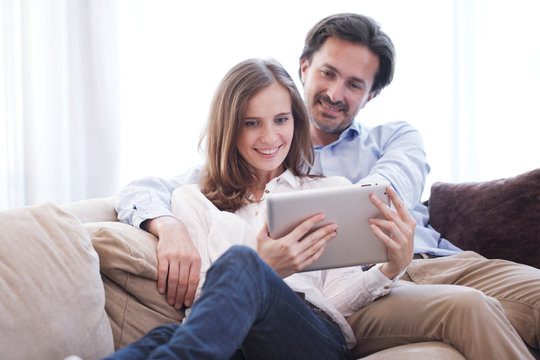 Cheerful Couple Using Tablet