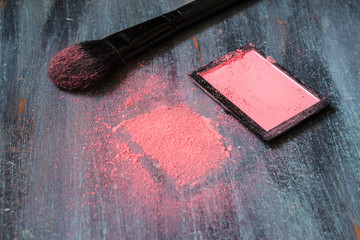 Blush and brush black on blue gray painted wooden background