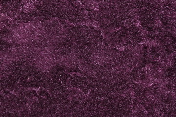 Purple fluffy carpet texture of textile for blank and pure backgrounds